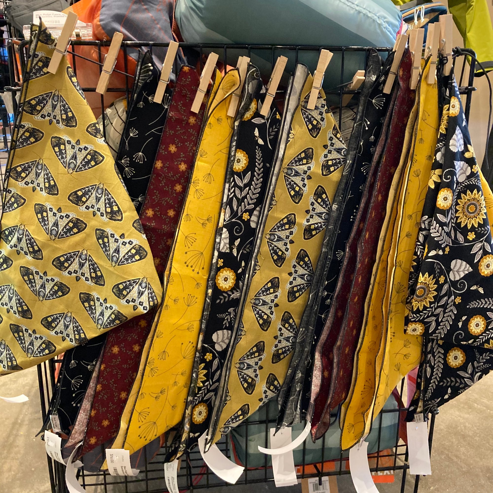 An image of a variety of colorful bandanas hanging on a display.